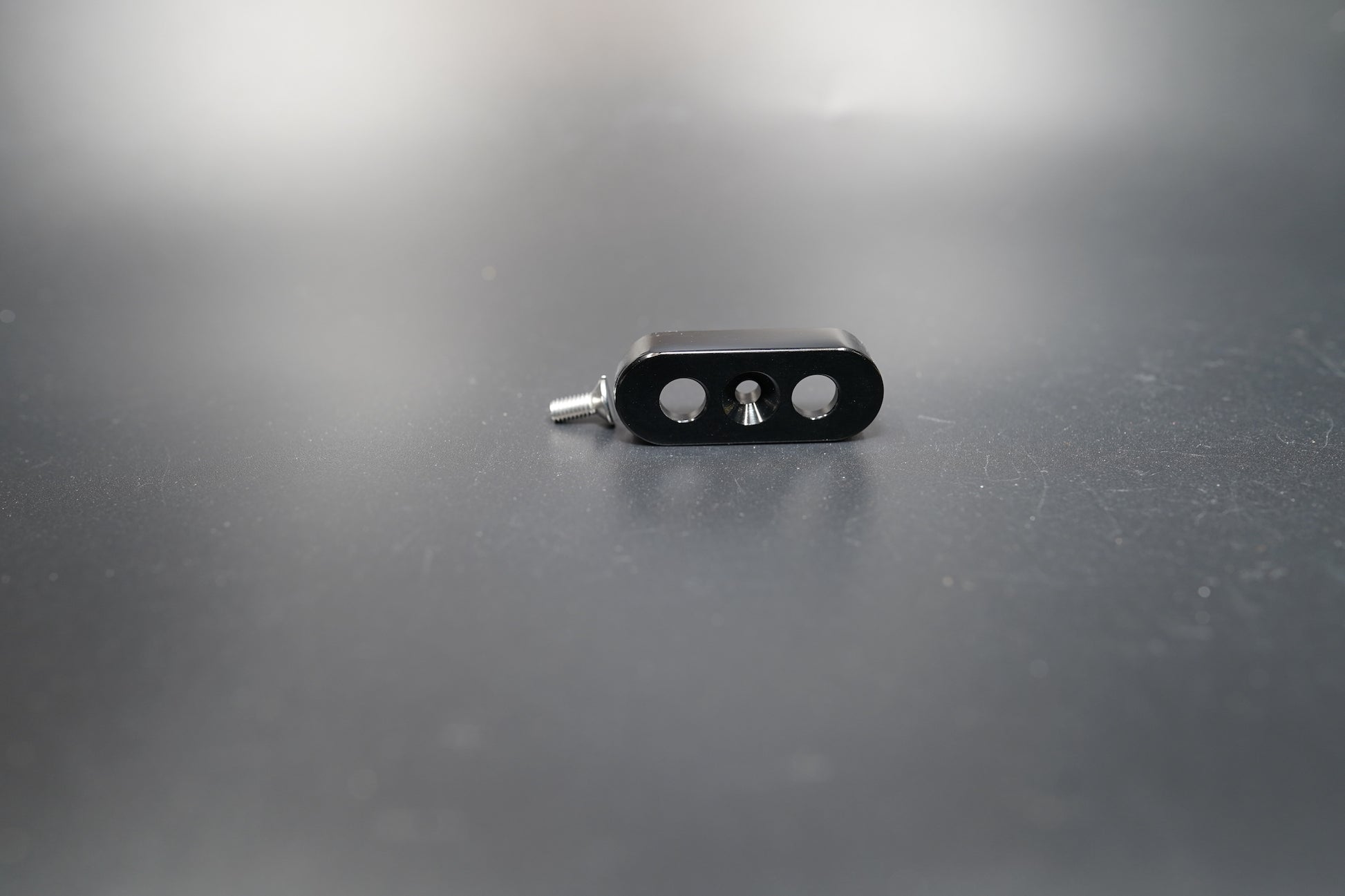 Side profile of black switch mount showing hole alignment 