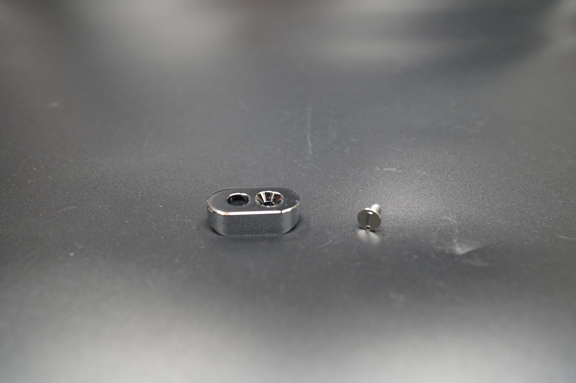 Silver switch mount with included screws and wrench