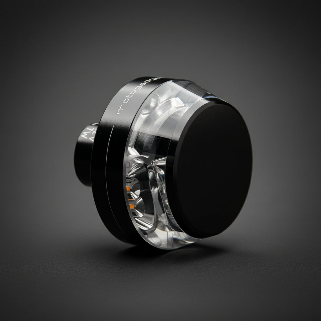 Close-up of illuminated mo.blaze disc LED indicator glowing in the dark — minimal, powerful 360° visibility.