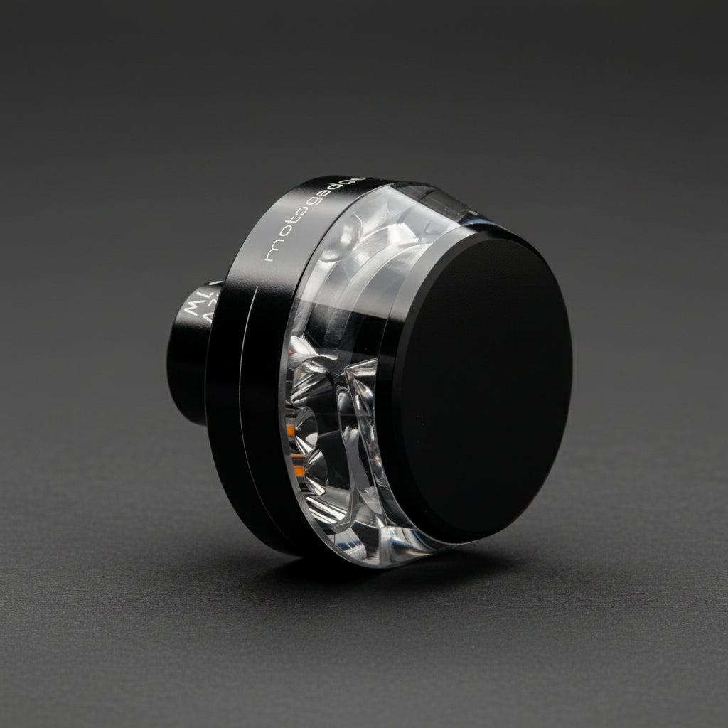 Front angled view of Motogadget mo.blaze disc — 360° LED bar-end indicator with crystal-clear lens and black housing.