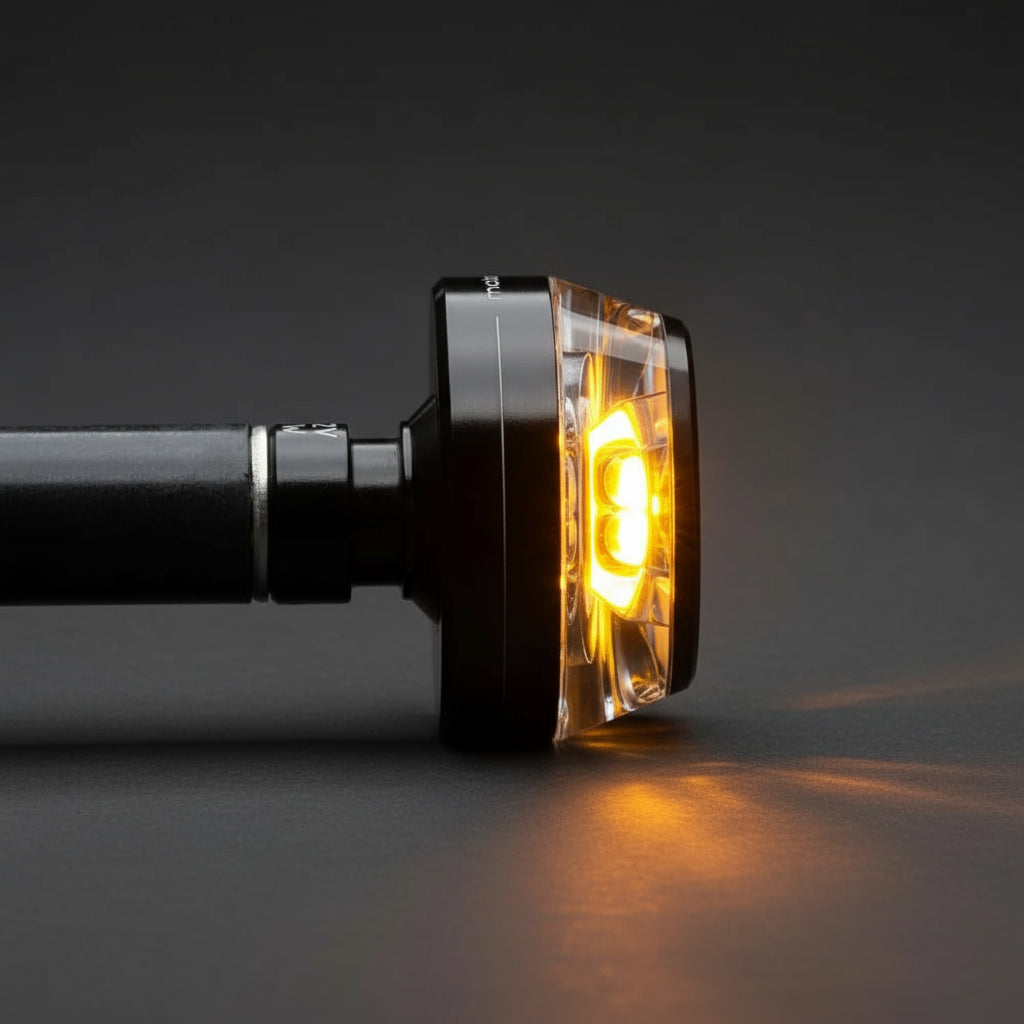 Side profile view of mo.blaze disc — compact 35 mm design with warm amber light and CNC-machined finish.