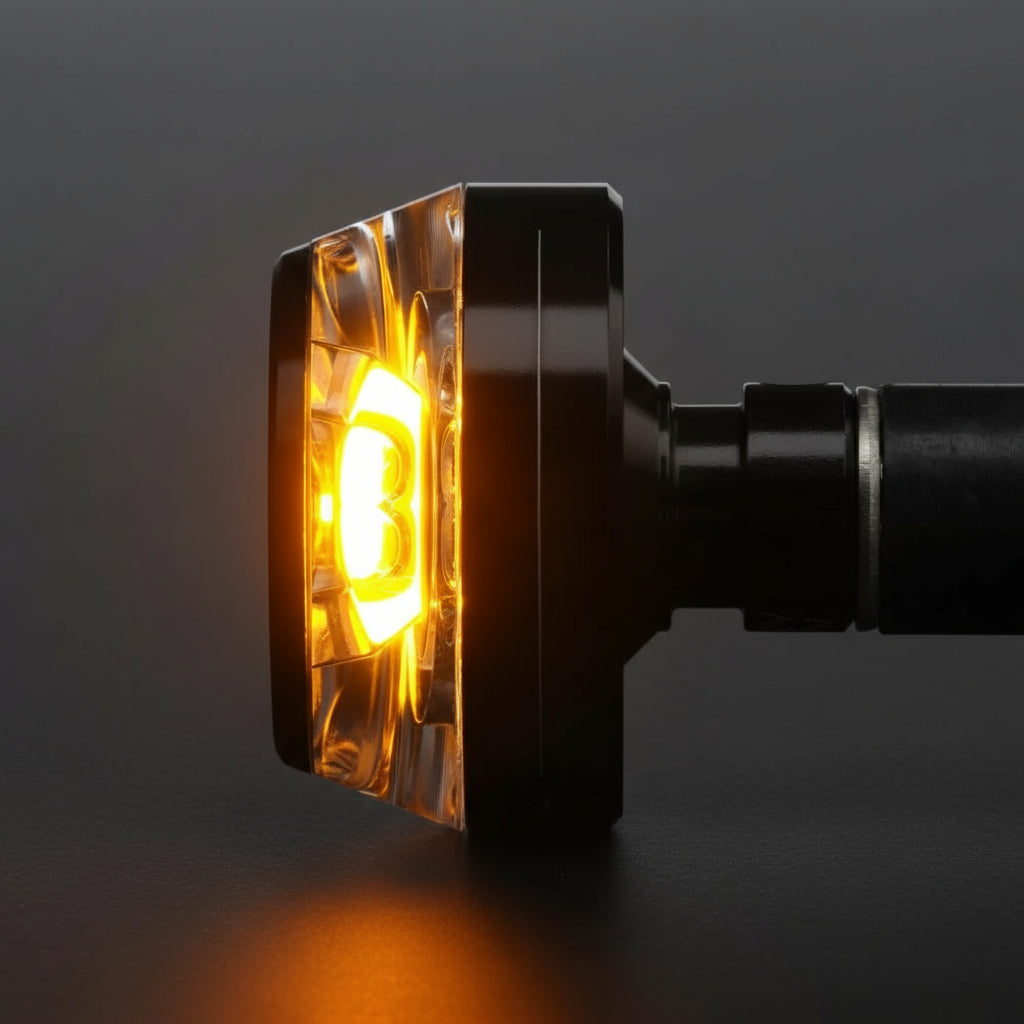 Detailed shot of mo.blaze disc emitting amber light — seamless optical diffusion for forward, side, and rear visibility.