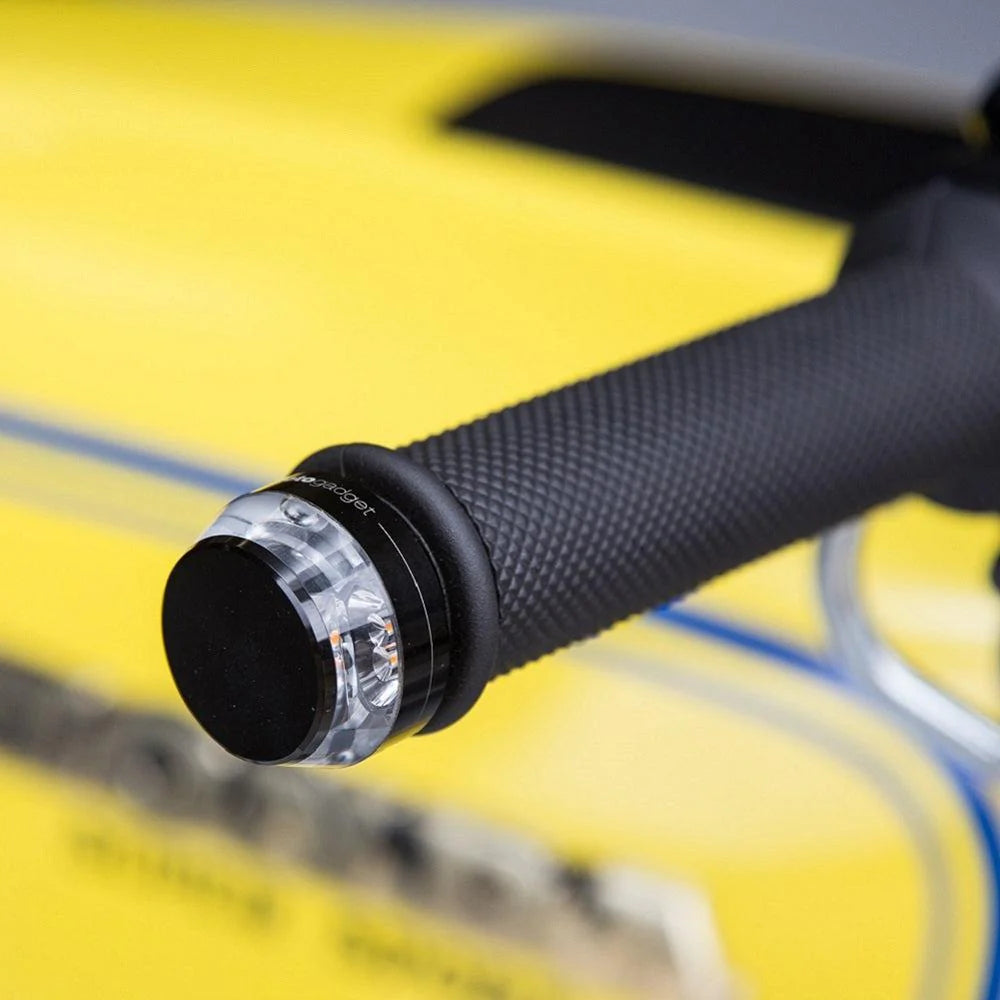 Motogadget mo.blaze disc installed on motorcycle handlebar — sleek 360° LED turn signal integrated into bar end.