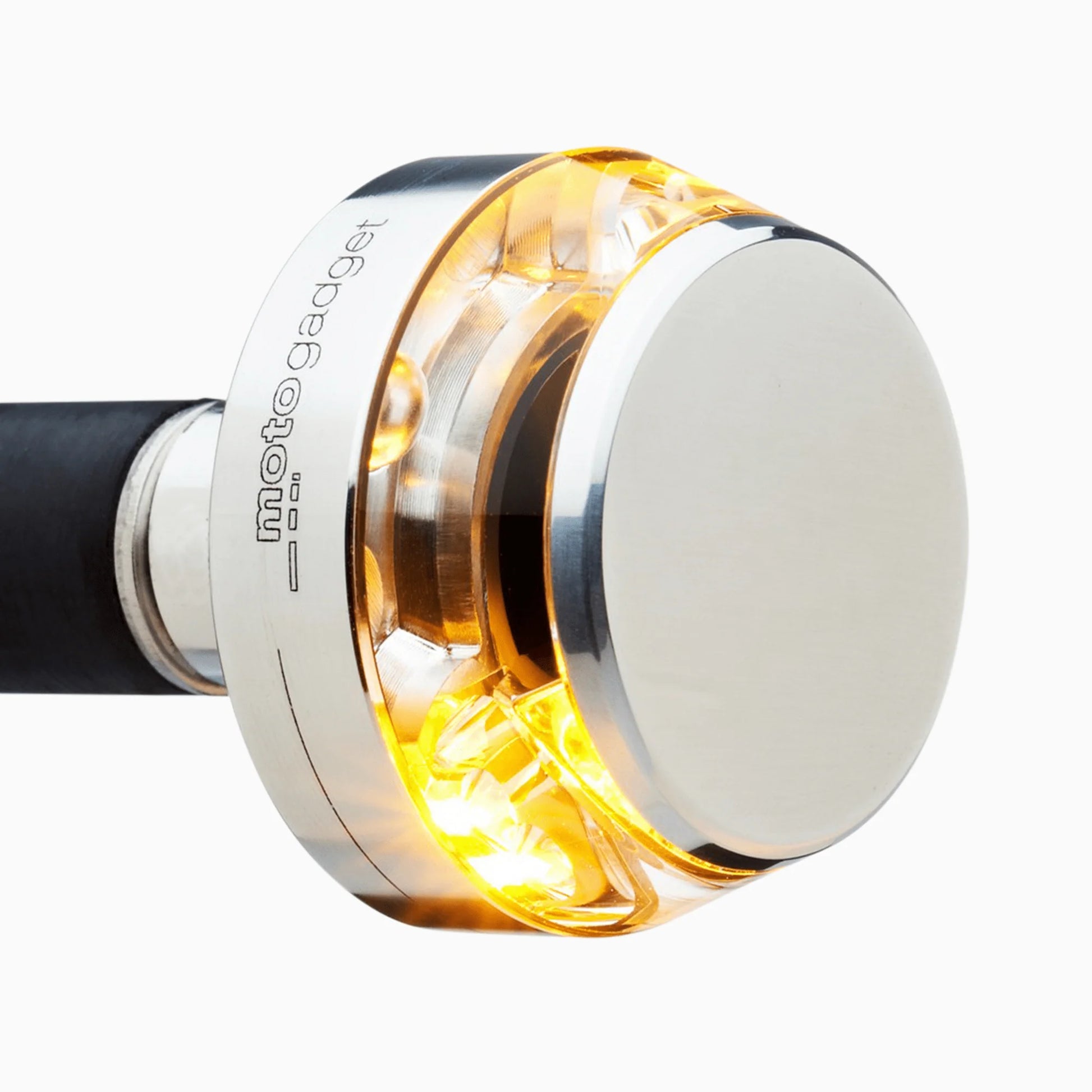 Side profile view of mo.blaze disc — compact 35 mm design with warm amber light and CNC-machined polished finish.