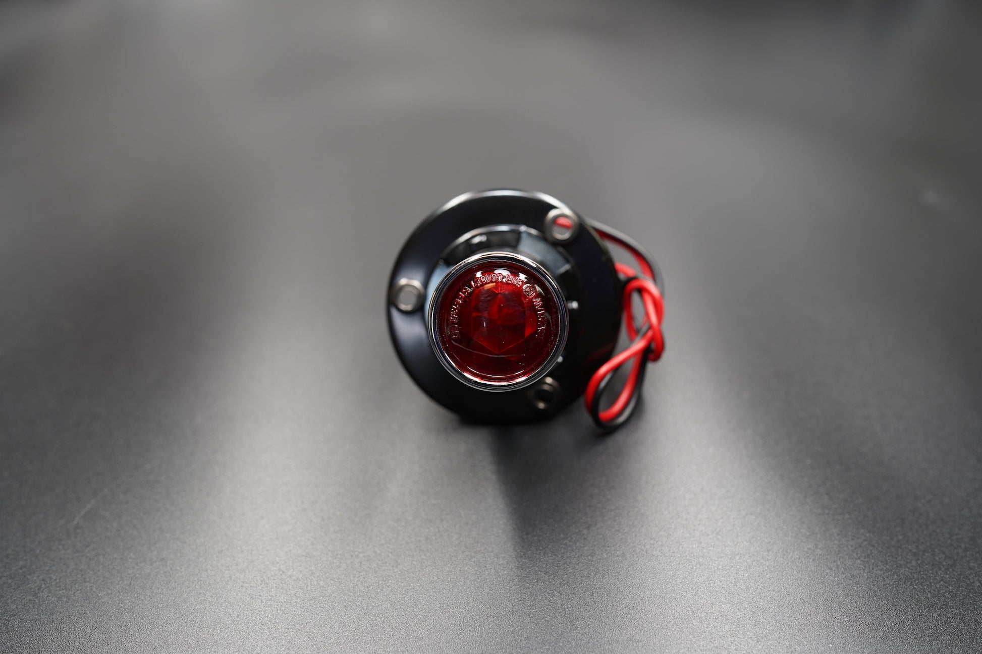 Underside view showing mounting holes and cable entry point.