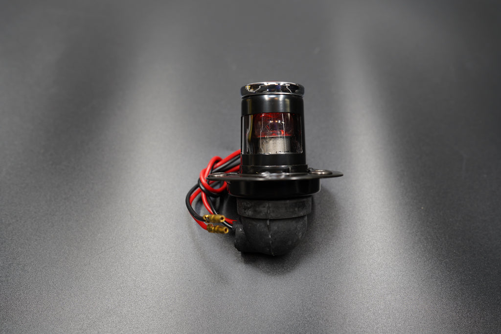 Close-up of license plate mount detail — metal bracket and LED unit connection.