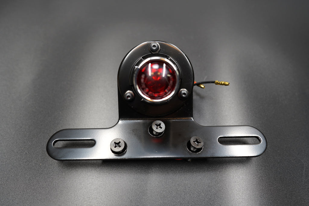 Close front angle highlighting LED lens glow and plate mount structure.