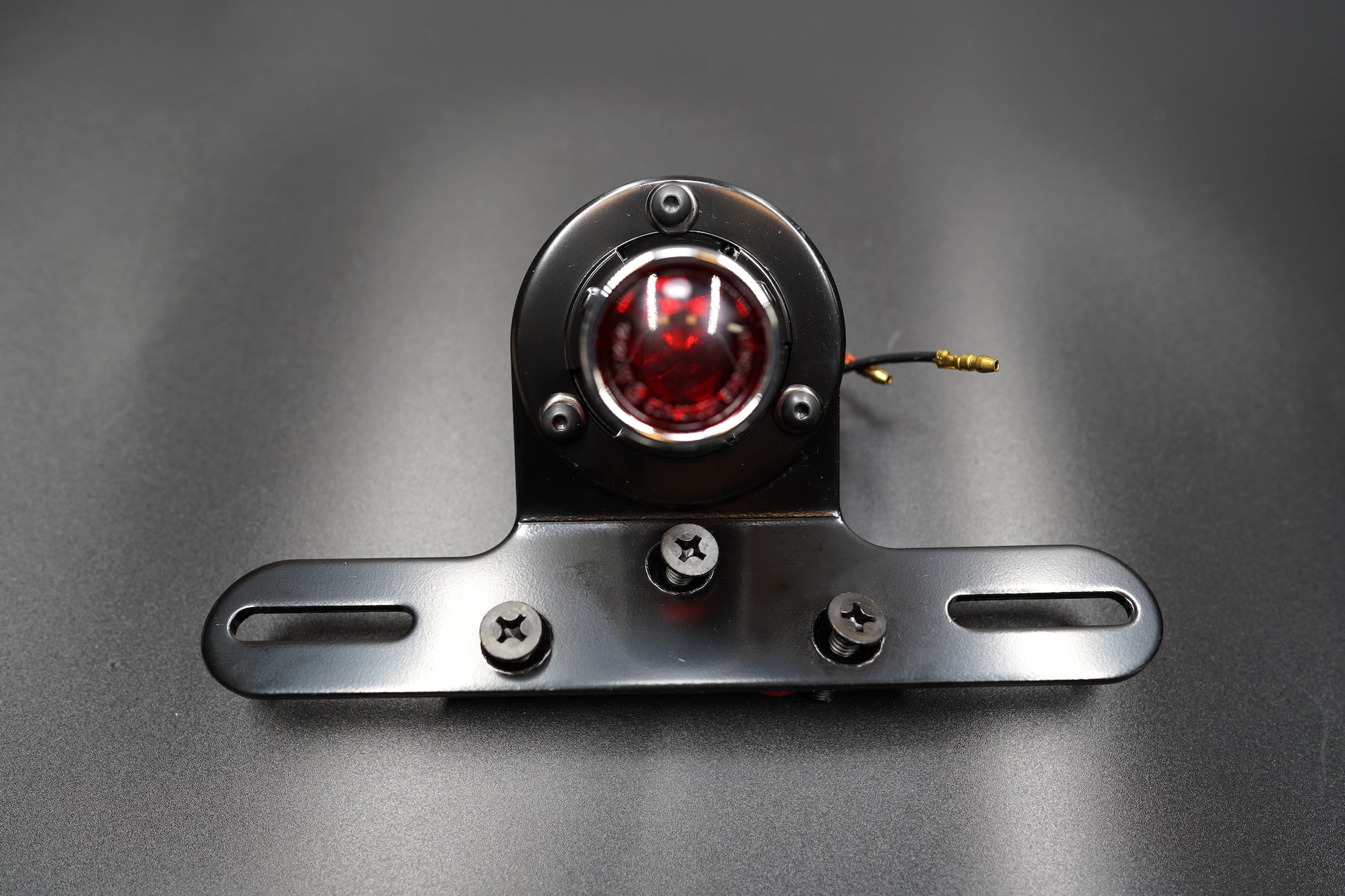 Close front angle highlighting LED lens glow and plate mount structure.