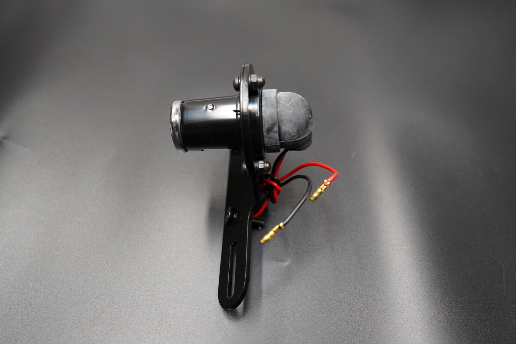 Left side profile showing curved housing and compact bracket form.