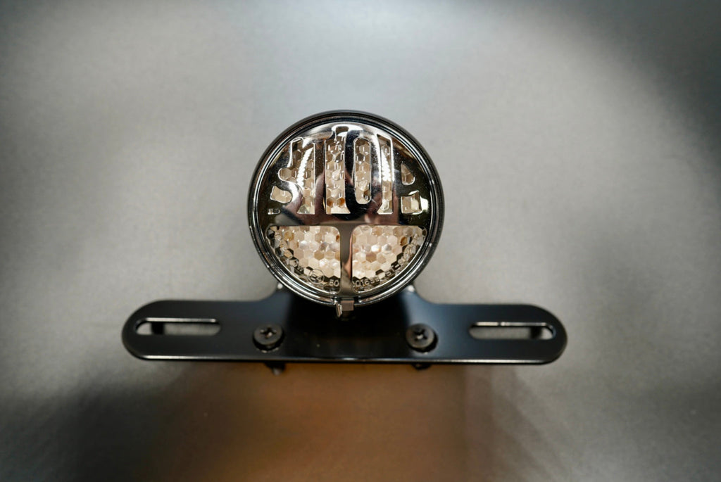 LED STOP tail light front view with chrome STOP lettering