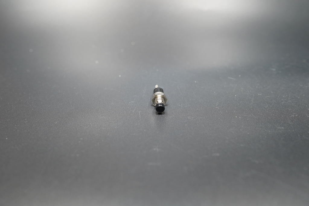 Black version of motorcycle push button switch on neutral background