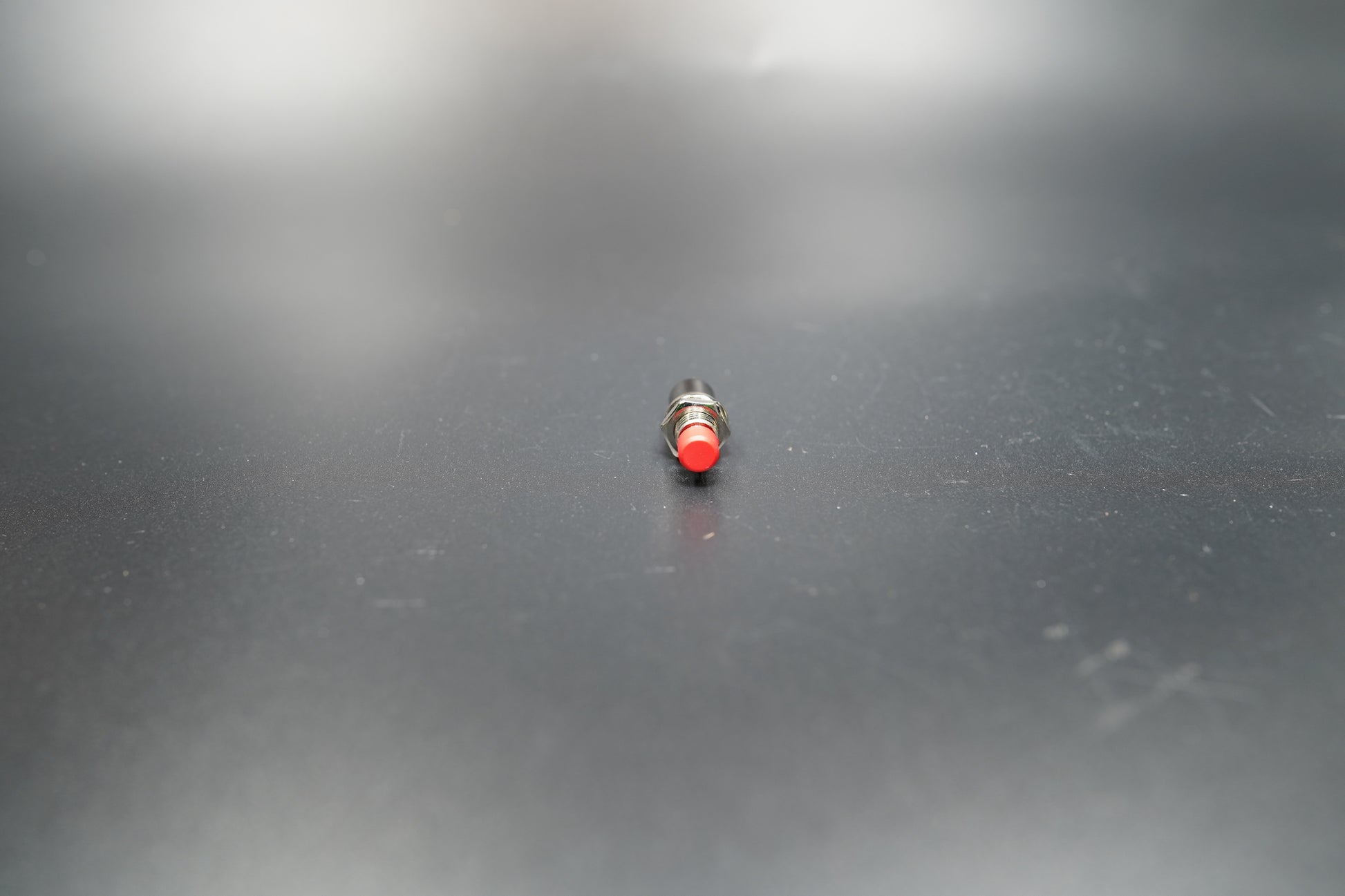 Angled shot of red push button motorcycle control switch 