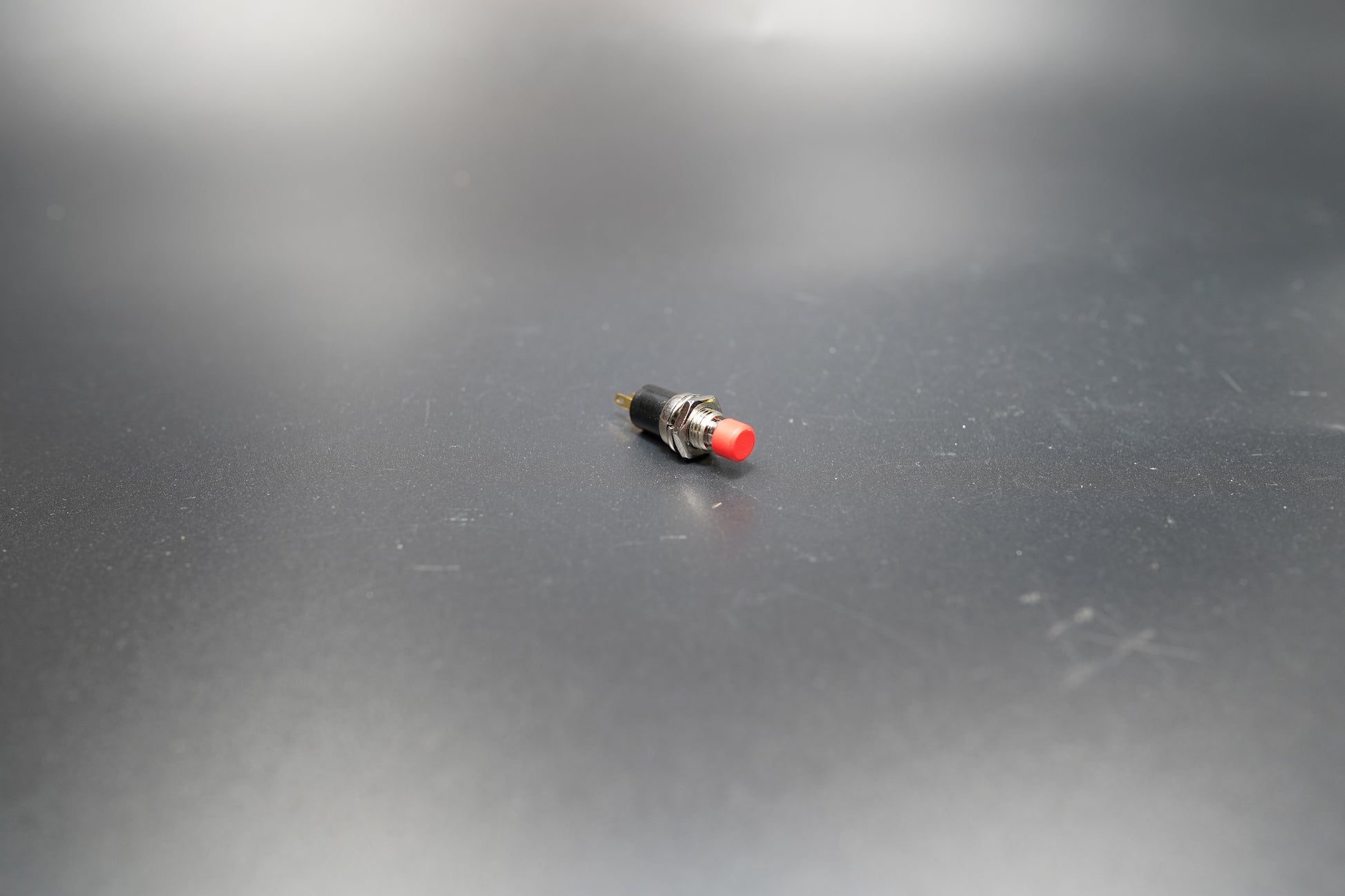 Close-up detail of red push button switch top 