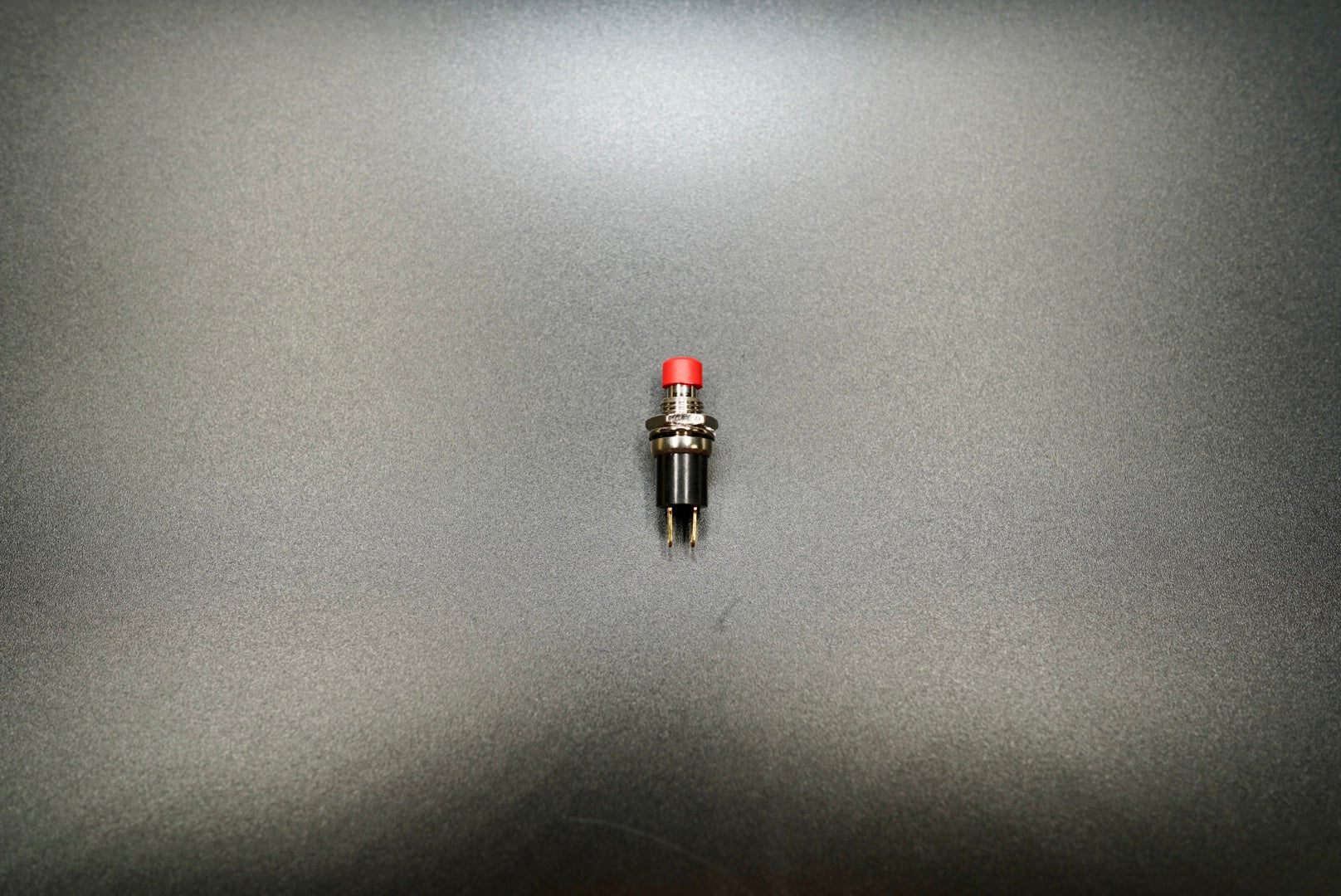  Red push button switch top view on matte surface