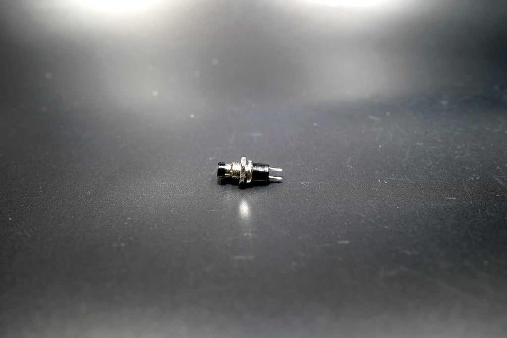 Side view of ON-OFF push button switch showing threaded mount 