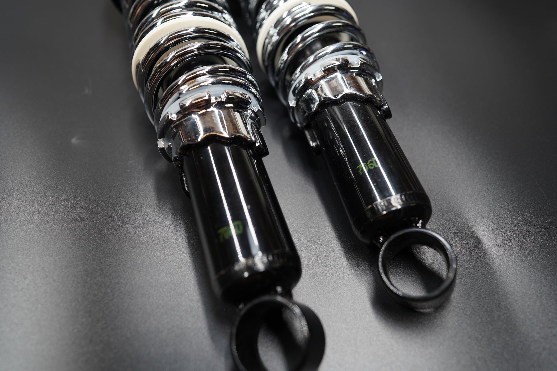 Close-up top angle showing polished coil springs and black damping body.