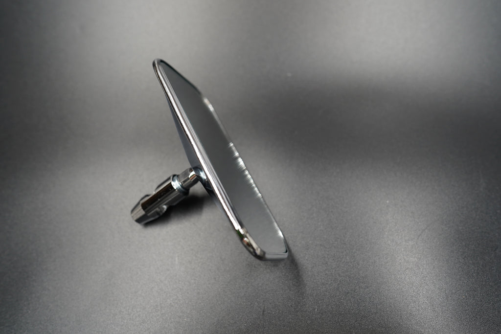 Flat-lay image of rectangular mirror — lightweight aluminium body emphasizing functional simplicity.