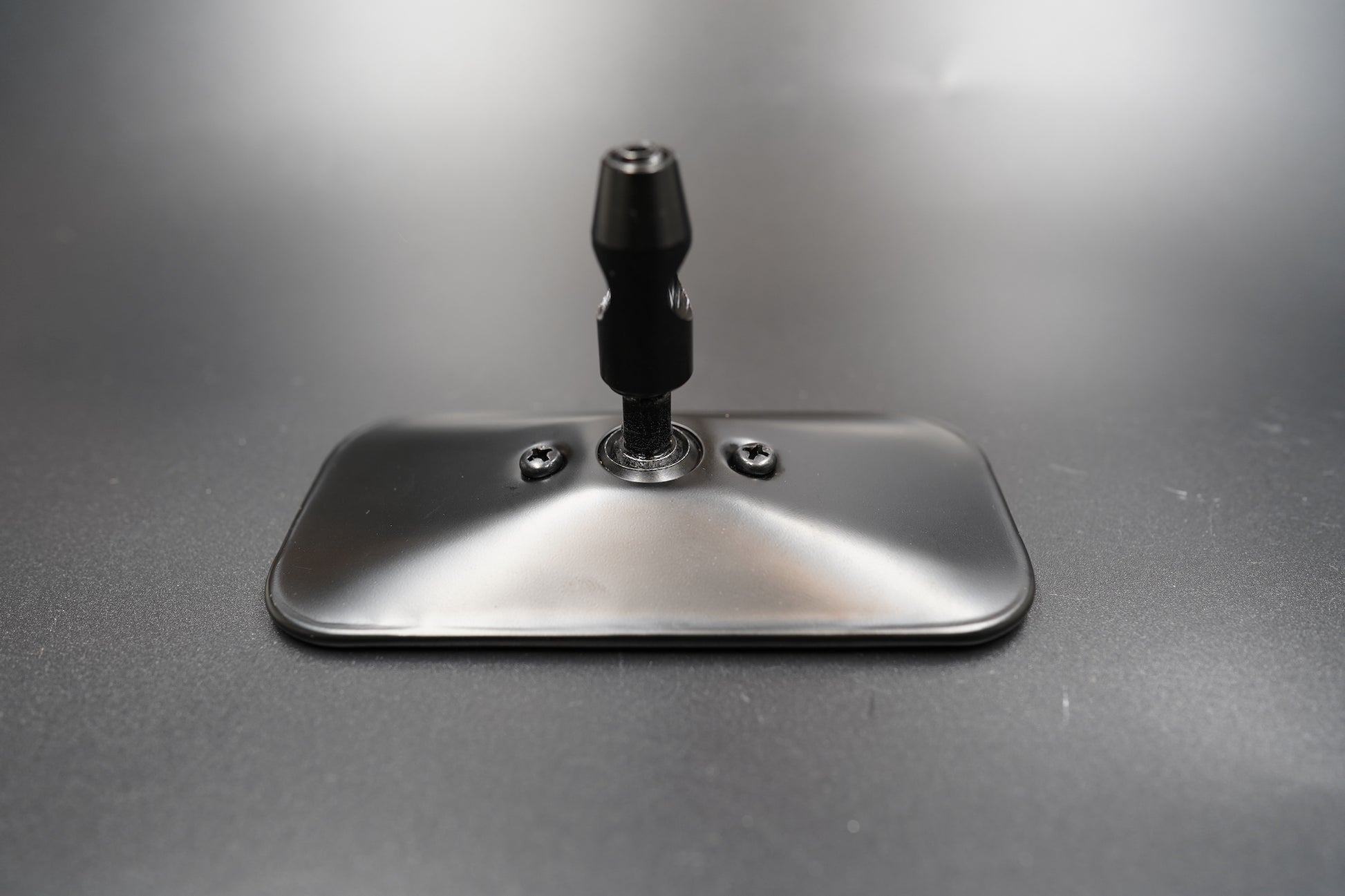 Front view of rectangular vintage rearview mirror — minimalist metal design with matte black and polished silver finishes.