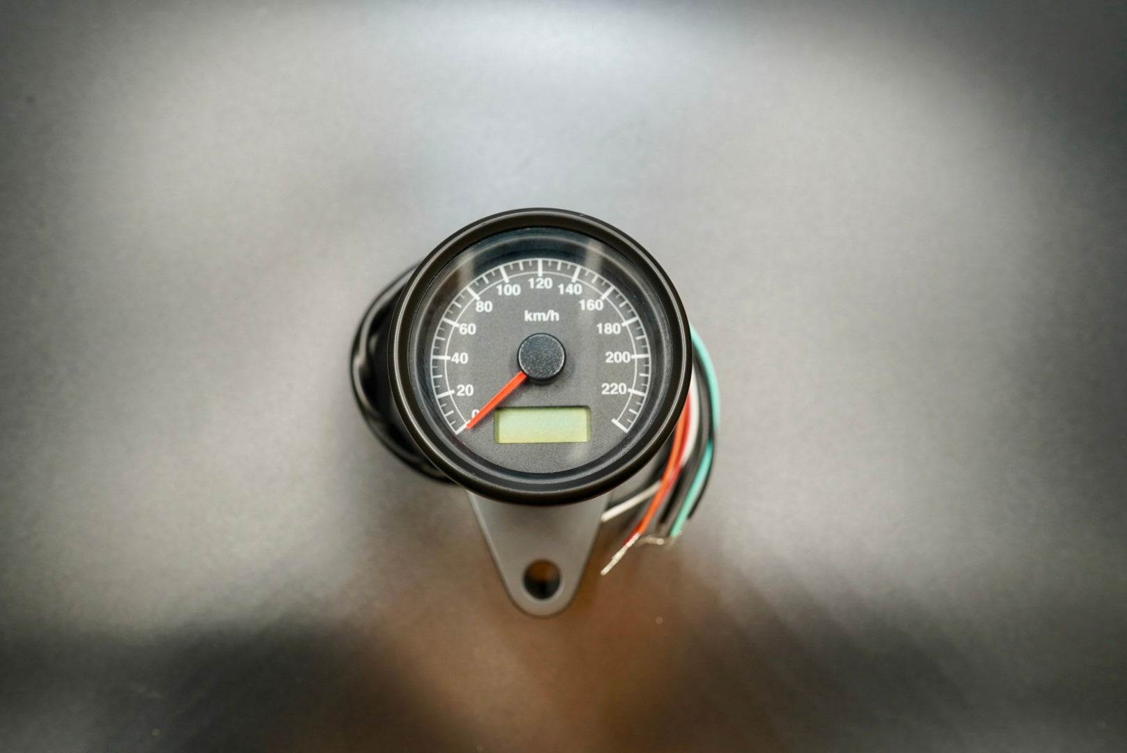 Retro-style 60mm electronic motorcycle speedometer, black housing front view, 0–220 KMH dial.