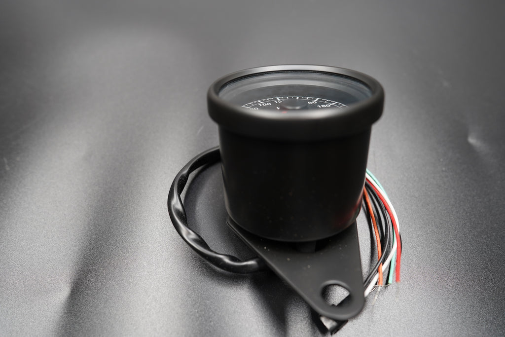 Top view of compact 60mm speedometer with classic black dial and chrome ring.