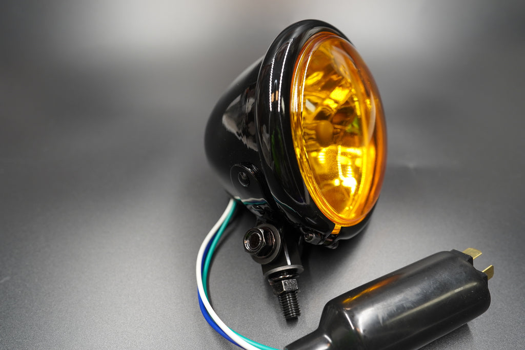 Angled front view highlighting powder-coated steel housing and subtle amber hue.