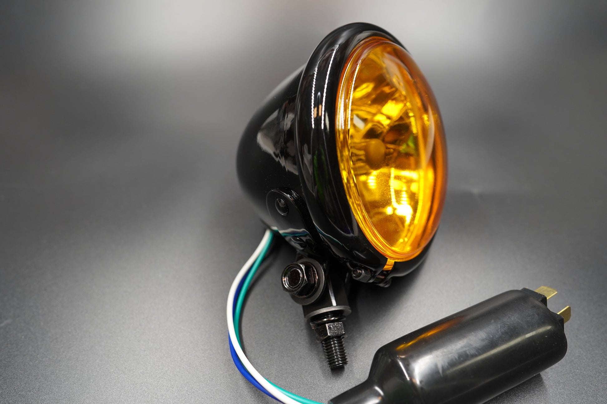 Angled front view highlighting powder-coated steel housing and subtle amber hue.