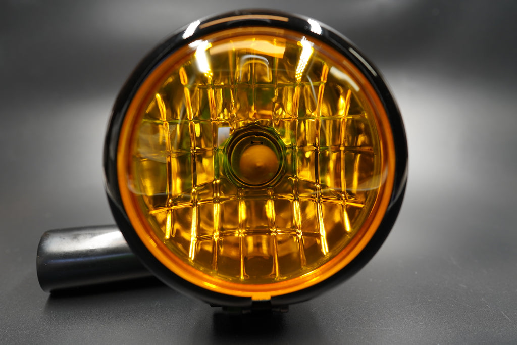 Close-up of amber diamond lens showing soft warm glow and vintage detailing.
