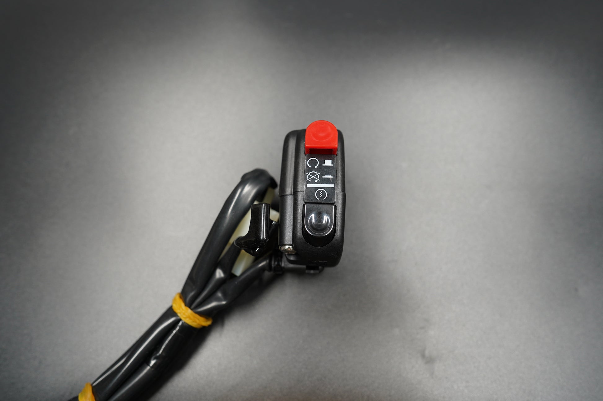 Angled shot focusing on texture of black plastic and red switch