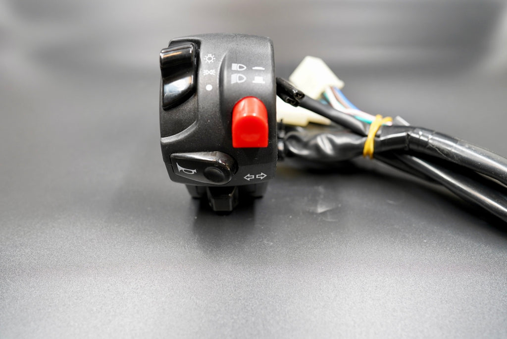 Left-hand switch unit for horn, turn signals, and headlight control.