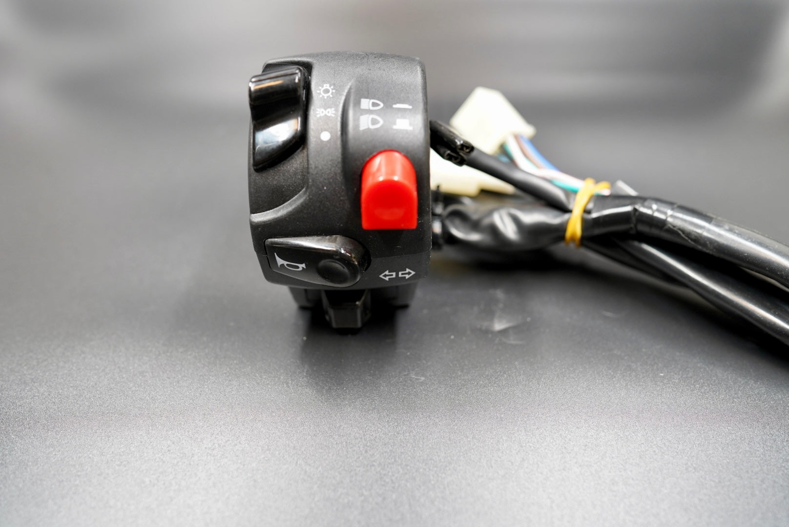 Left-hand switch unit for horn, turn signals, and headlight control.