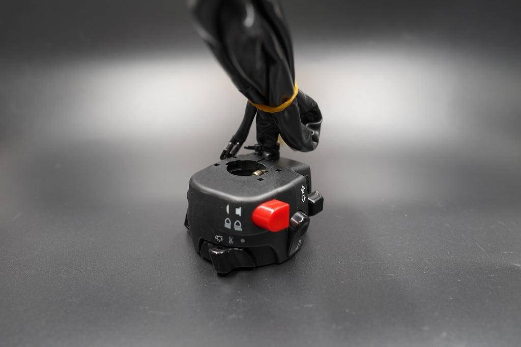 Top-down angle displaying red button and layout of switch positions.