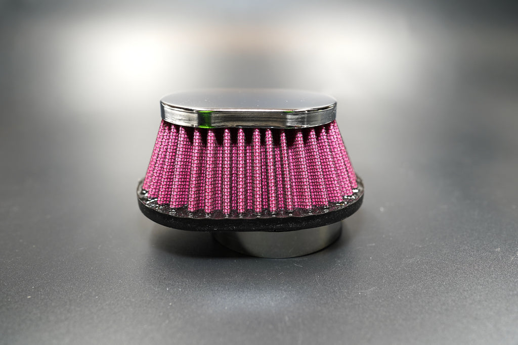 Side profile showing pleated red filter body and chrome top cap.  