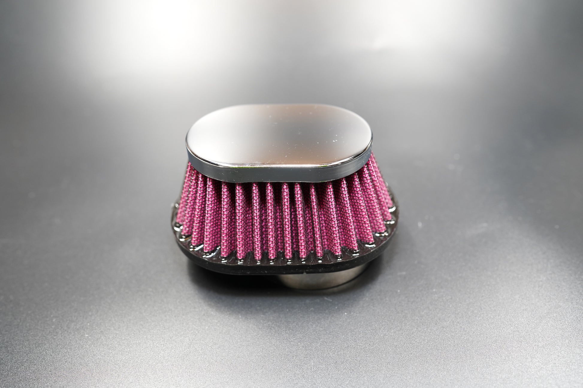 Top-down view of the chrome oval cover and pleated design.