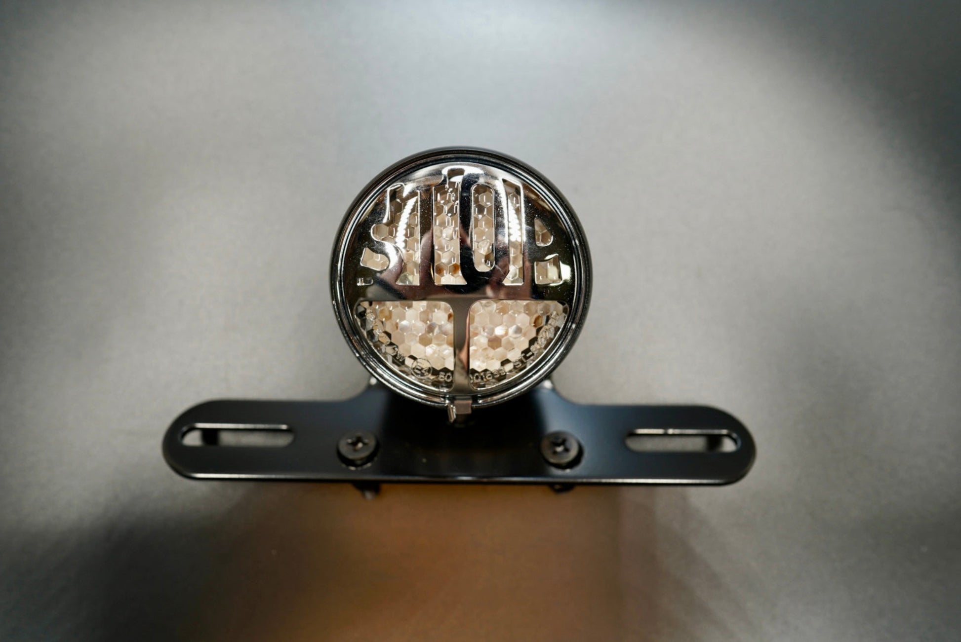 Close-up showing chrome “STOP” lettering and LED array under clear lens.