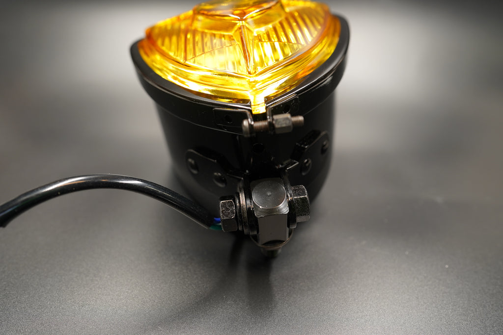 Amber version illuminated — warm tone under lighting, soft reflection.