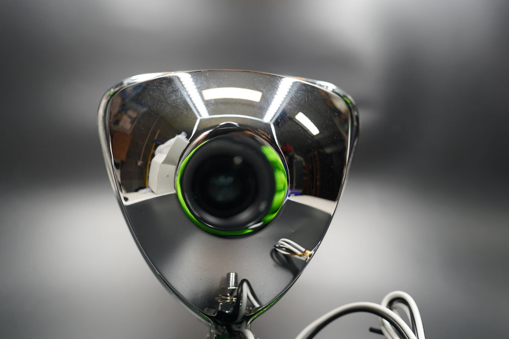 Clear lens close-up — light dispersion detail and chrome finish.