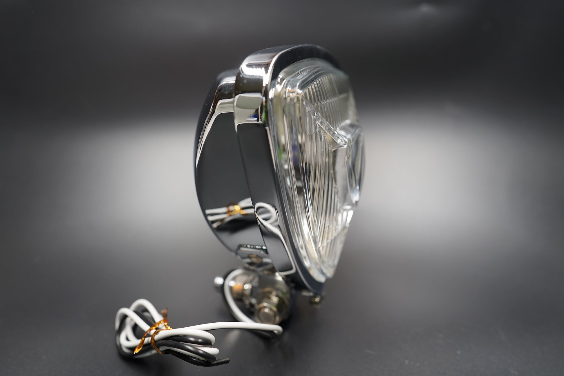 Side view of clear lens model with chrome trim and reflective depth.