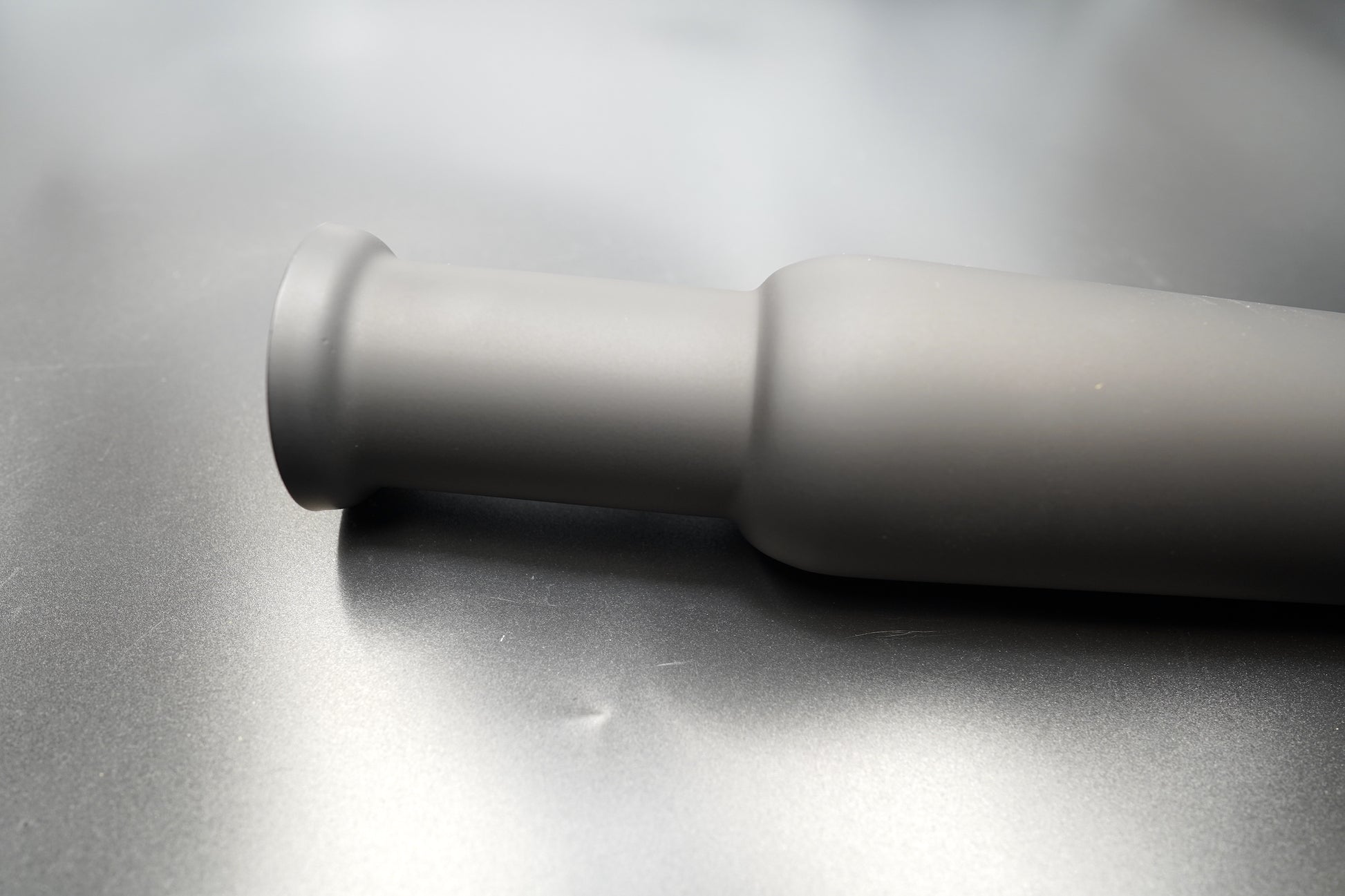 Angled perspective of matte black silencer body.