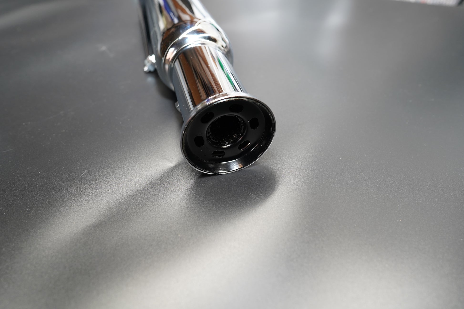 Chrome version surface detail highlighting polish and reflection.