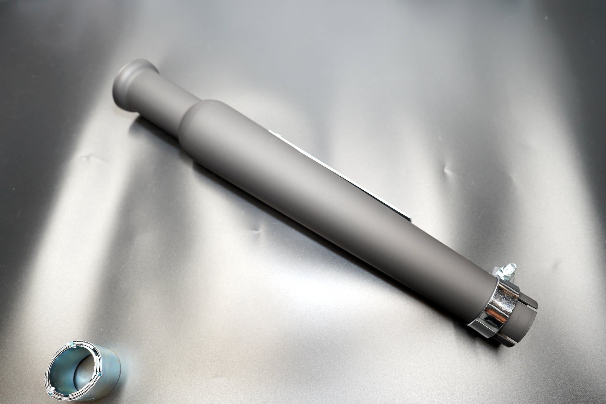 Black version layout with reducer and clamp on matte surface. 