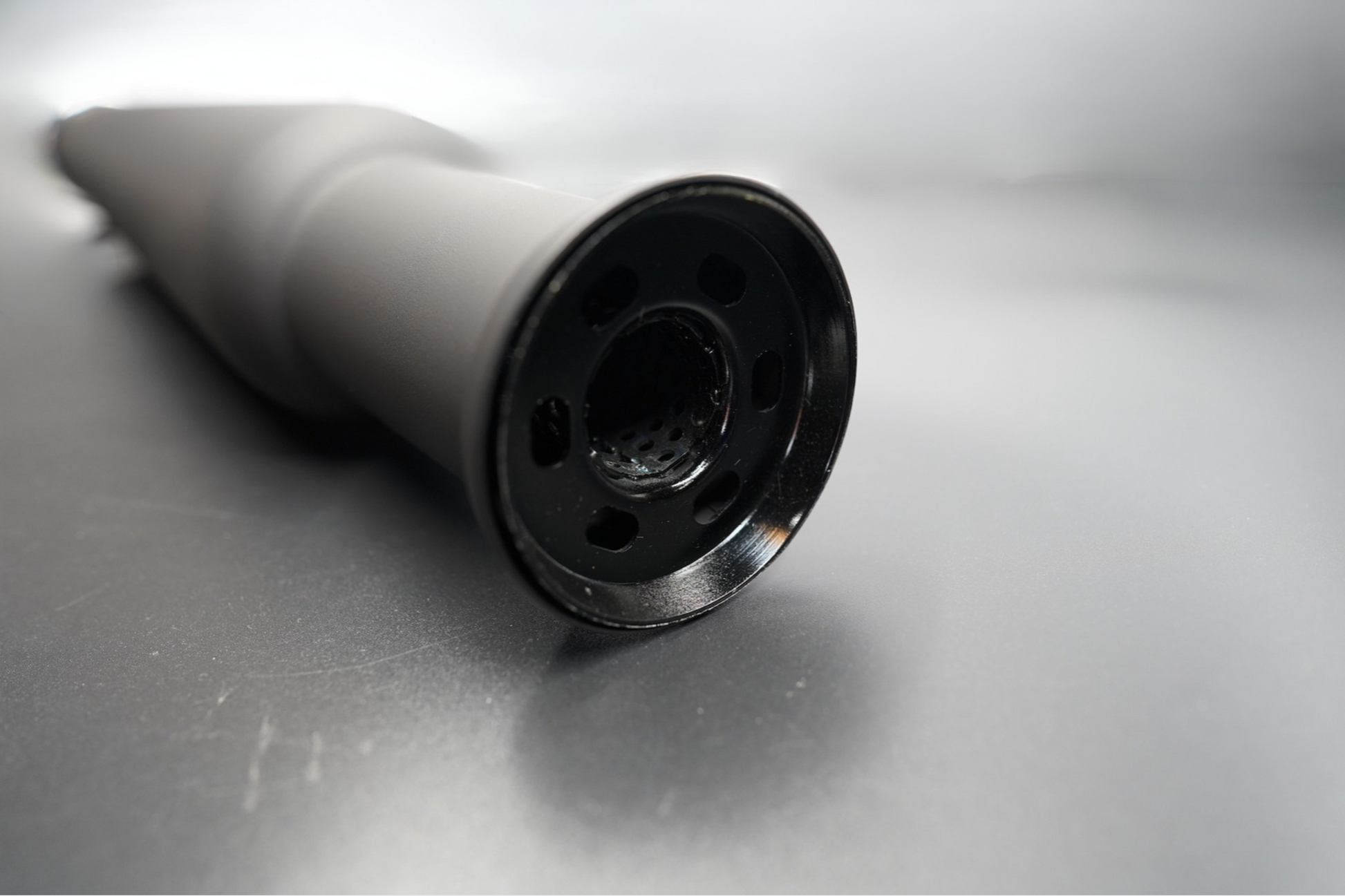 Chrome exhaust tip close-up showing internal cone detail. 