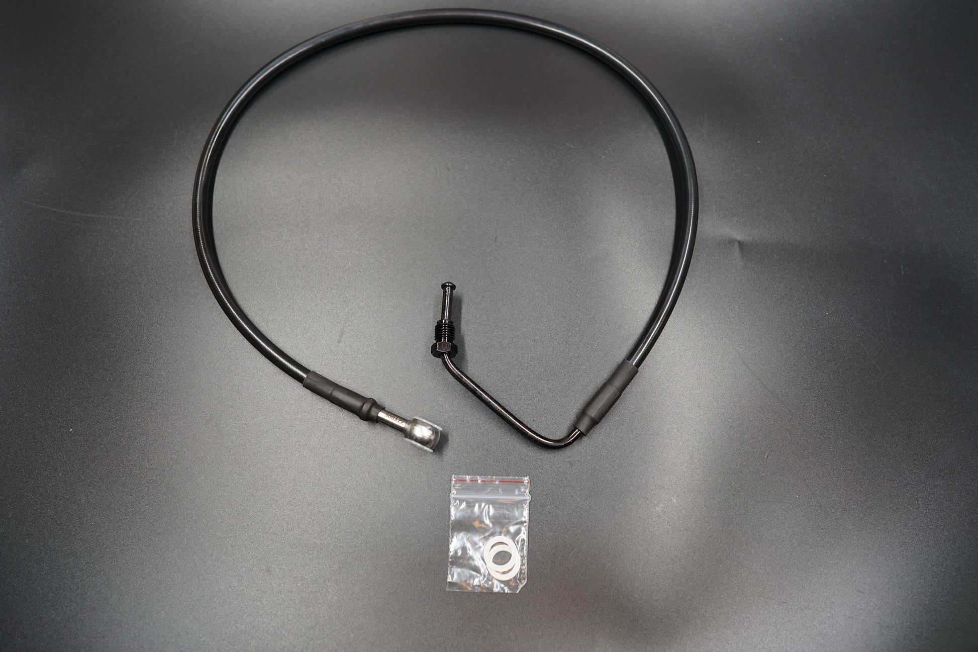 Close-up view of Triumph Bobber brake master cylinder cable connectors and fittings