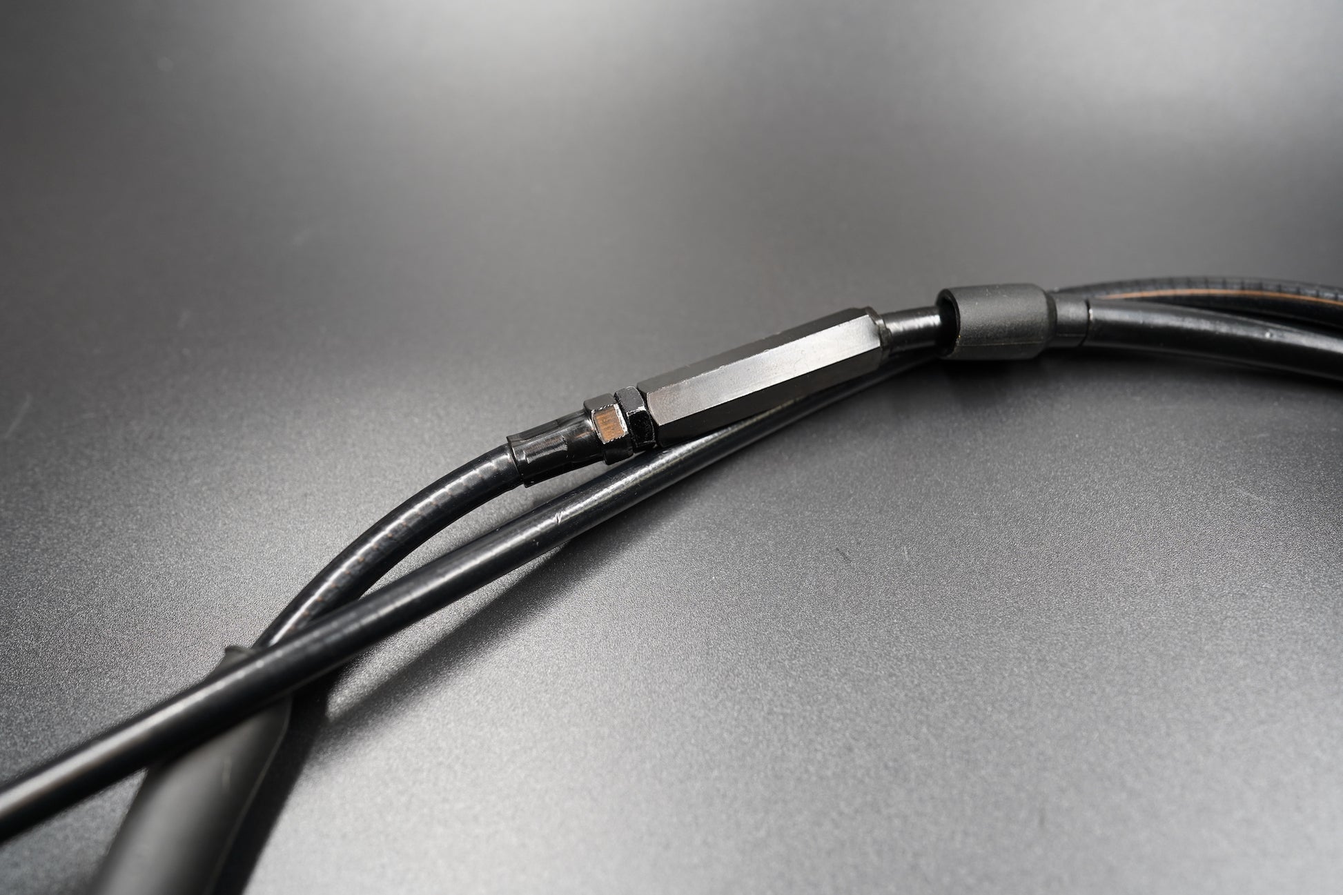 Close-up of Triumph Bobber clutch cable connector and sheath detail 