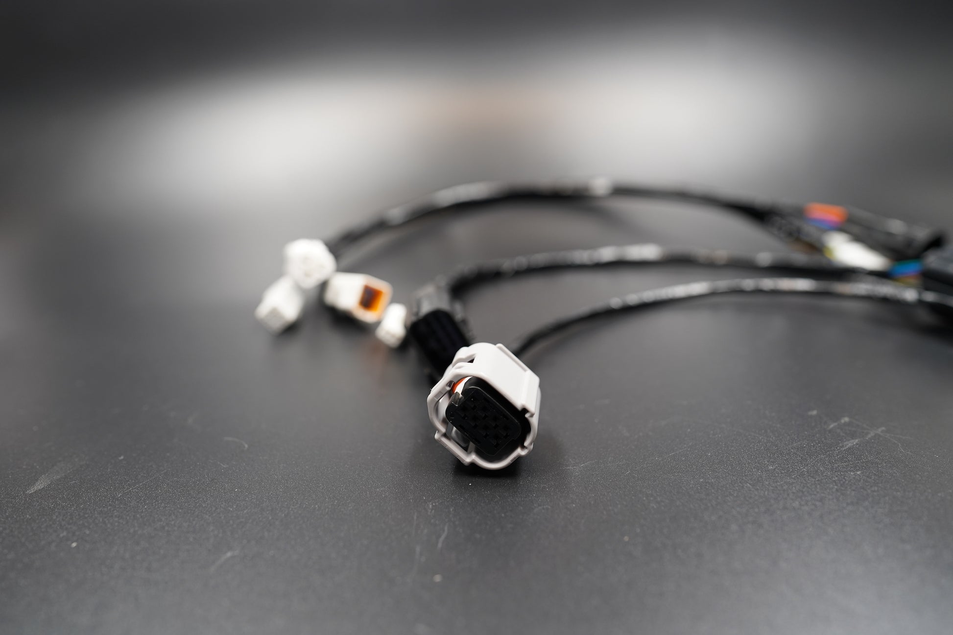 Close-up of Triumph Bobber Speedmaster wiring extension connector and braided cable