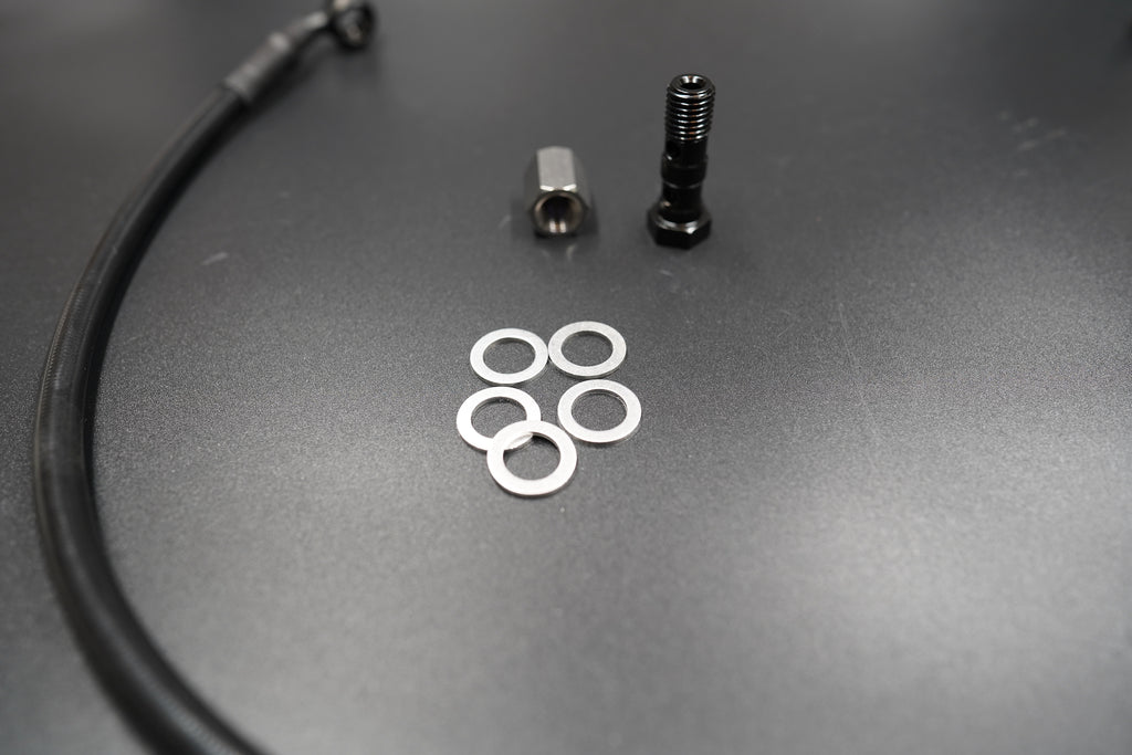 Close-up of Triumph T120/T100 brake cable connector and fitting components