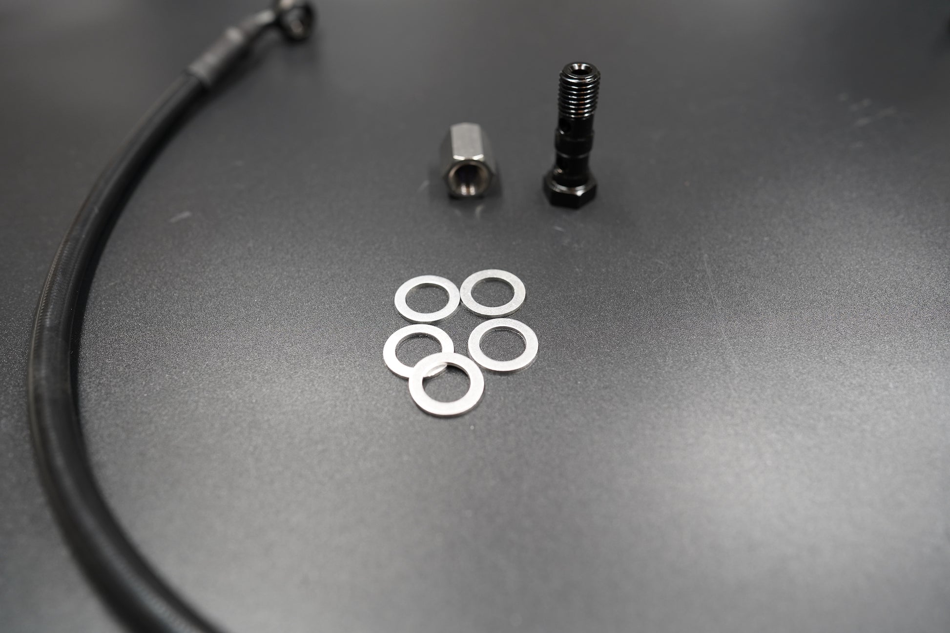 Close-up of Triumph T120/T100 brake cable connector and fitting components