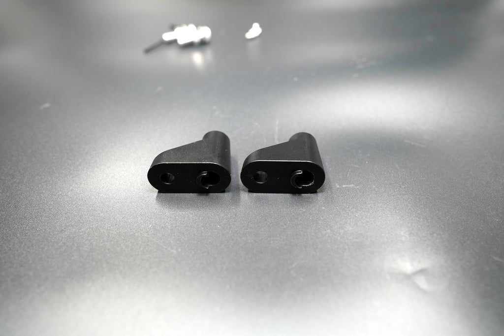 Close-up view of Triumph turn signal spacers showing matte black anodized finish