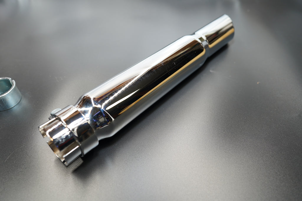 Close-up of polished chrome surface and welded seam detail.