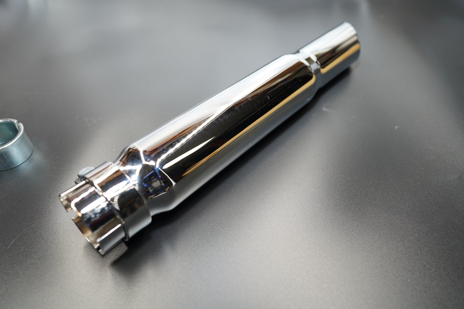 Close-up of polished chrome surface and welded seam detail.