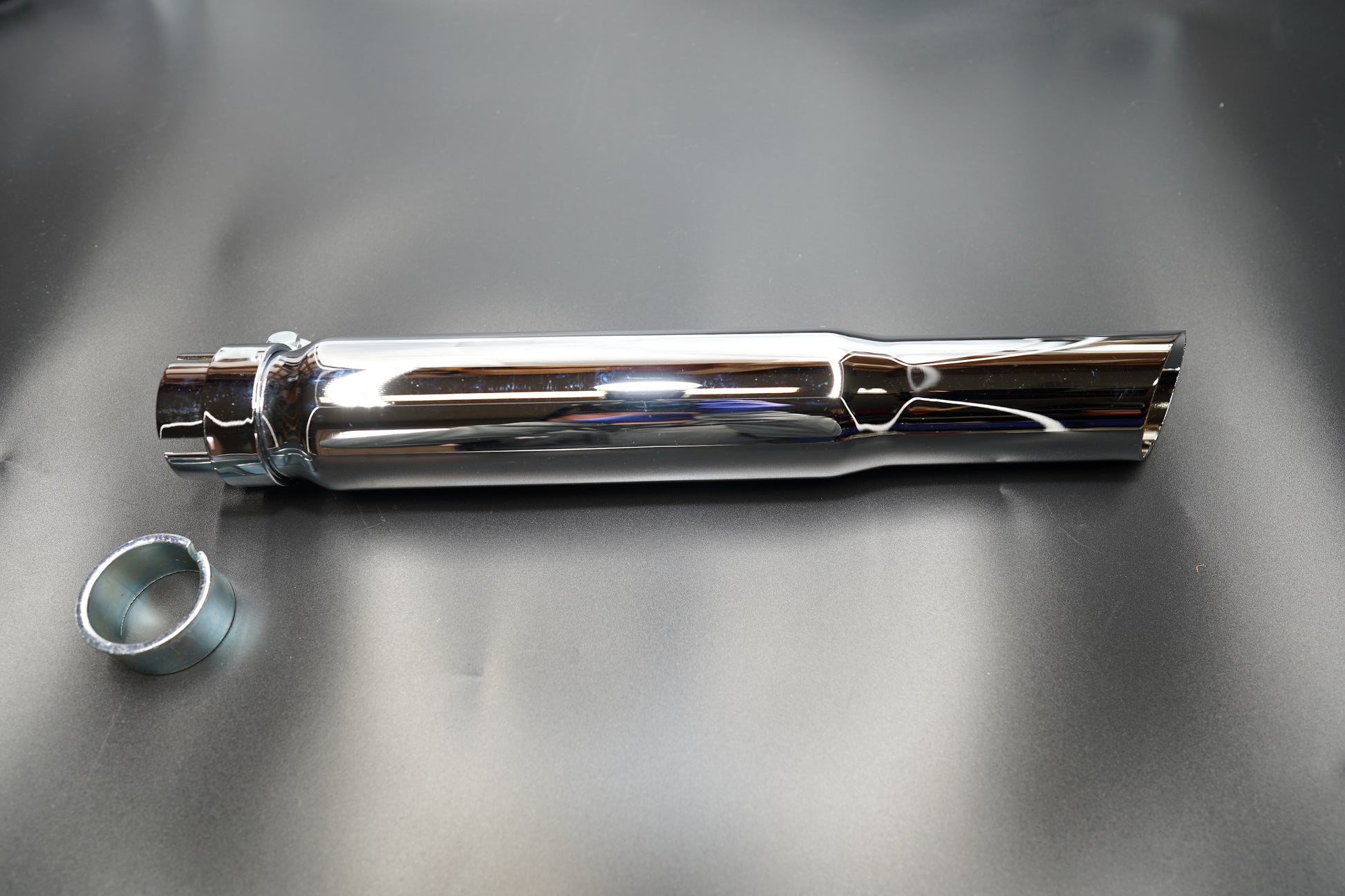 Top-down view of silencer body and included clamp hardware.